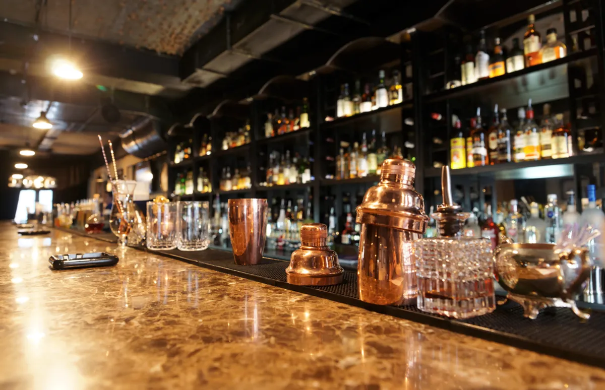 A bar counter lined with glasses