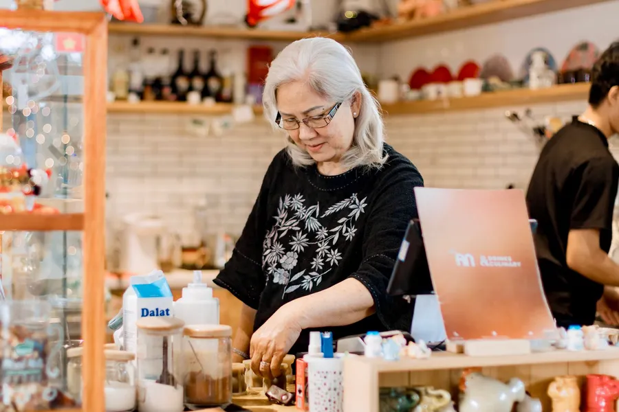 A shop owner working behind her counter